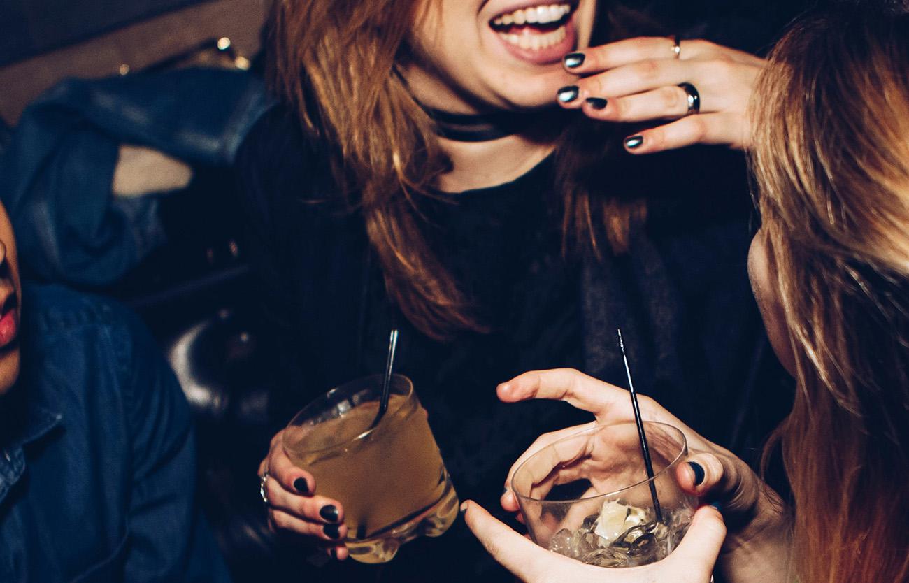 Close up of two women enjoying cocktails