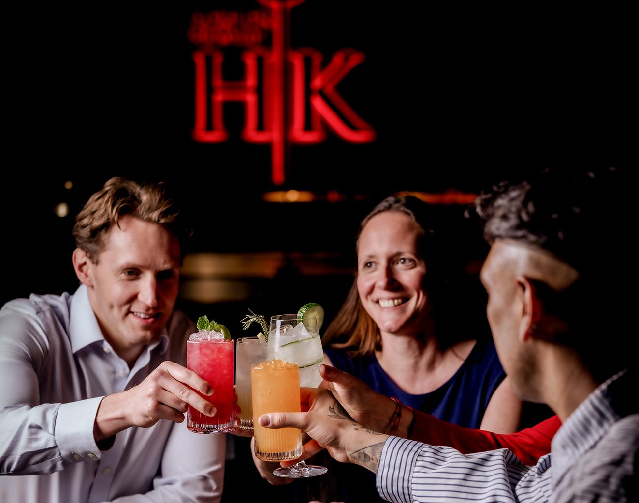 A group of friends enjoying drinks at Hell's Kitchen